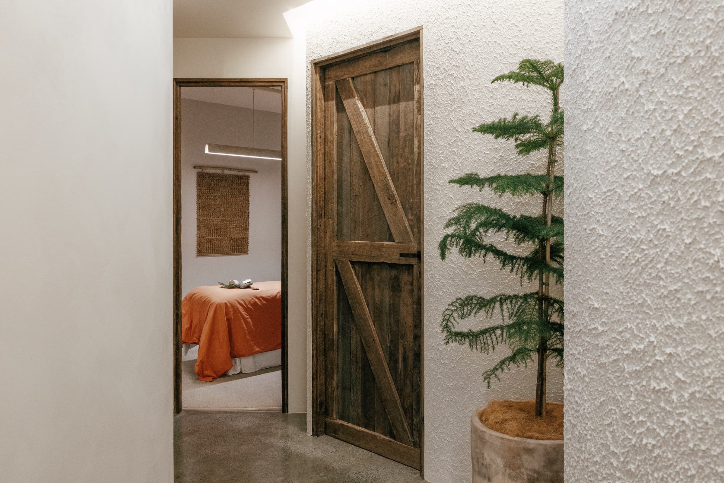Open doorway to a private massage room with the table freshly made, Navia Bathhouse Byron Bay